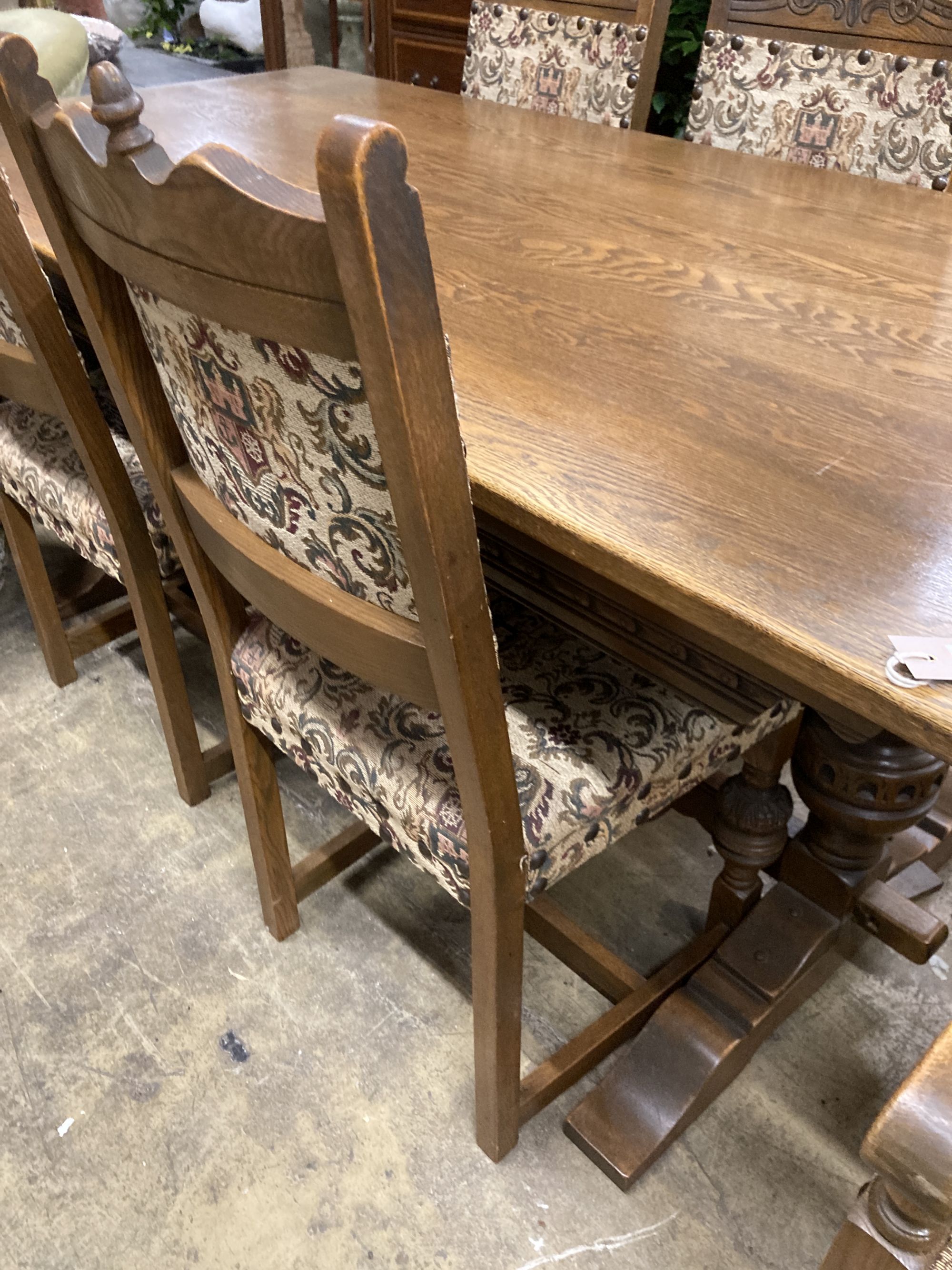 A rectangular 18th century style oak refectory dining table, length 182cm, depth 91cm, height 78cm, together with six matching dining chairs (two with arms)